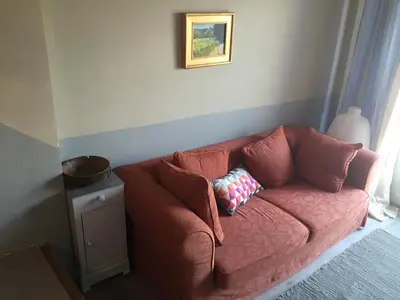 a brown couch with a pillow on top of it at 40 Rue du Ventoux in Bédoin