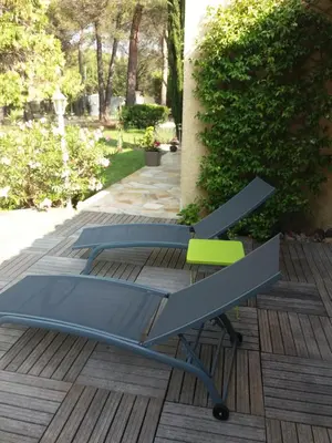 a bench and a table on a deck at Détente champêtre in Lambesc