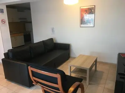 a living room with a couch and a table at Gites Velaux Ecureuil et Pinède in Velaux