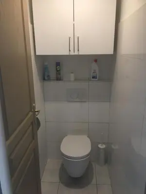 a small bathroom with a toilet and a cabinet at Gites Velaux Ecureuil et Pinède in Velaux