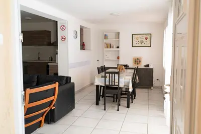a kitchen and living room with a table and chairs at Gites Velaux Ecureuil et Pinède in Velaux