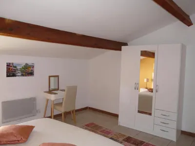 a bedroom with a bed and a table and a desk at Miel de Lavande in LʼIsle-sur-la-Sorgue