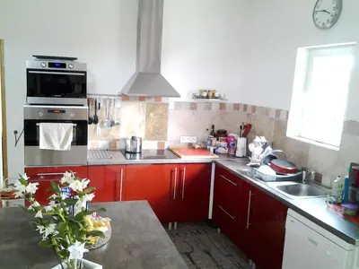 a kitchen with a sink and a stove top oven at Villa confortable avec piscine privée à Saint-Saturnin-lès-Apt in Croagnes