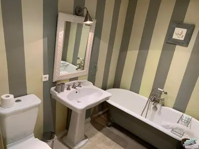a bathroom with a sink and a tub and a toilet at Villa Grenache, La Bastide de Marie, Villa avec services in Ménerbes