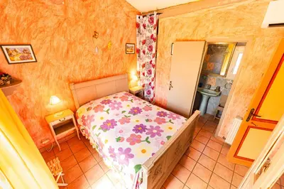 a small bedroom with a bed in a room at Bastide Les Basses Royères in Robion en Luberon