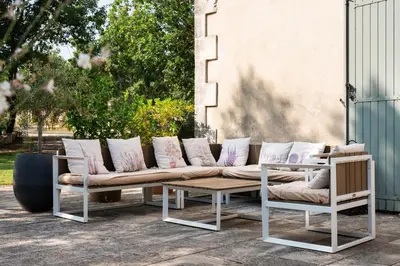 a couch and two chairs and a table on a patio at Maison d’Etienne in Lacoste