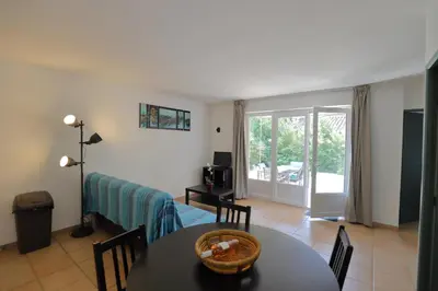 a living room with a table and a dining room at Au bastidon de Gordes in Gordes
