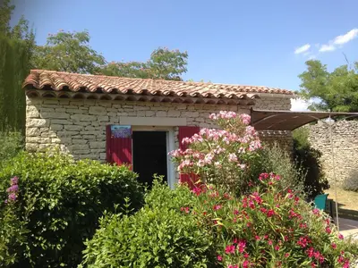 a small stone house with a red door at Au bastidon de Gordes in Gordes