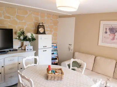a living room with a table and a couch at Location Bonnieux Provence in Bonnieux