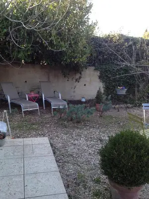 a group of chairs sitting in a garden at L'Oustalet in La Tour-dʼAigues