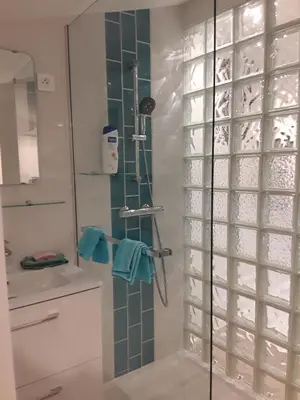 a shower with a glass door in a bathroom at Yofanto in Sénas