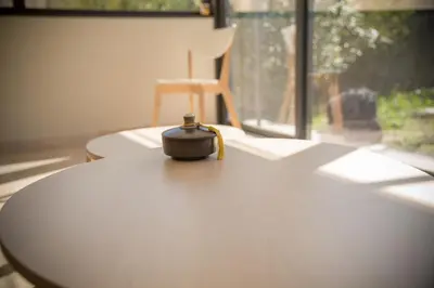 a remote control sitting on top of a table next to a window at A jewel by the river! in Fontaine-de-Vaucluse