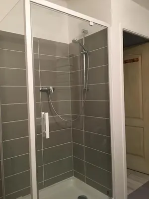 a shower with a glass door in a bathroom at Maison de village in Velleron