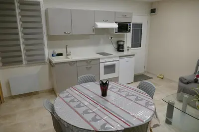 a kitchen with a table and chairs and a kitchen with a table and a kitchen at Les Hauts De Reillanne in Reillanne