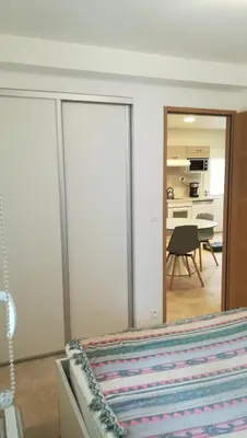a bedroom with sliding glass doors and a dining room at Les Hauts De Reillanne in Reillanne