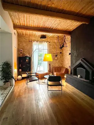 a living room with a couch and a fireplace at Maison Florence Ivakno in Coudoux