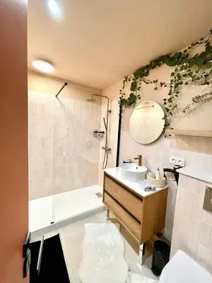 a bathroom with a sink and a shower and a mirror at Maison Florence Ivakno in Coudoux