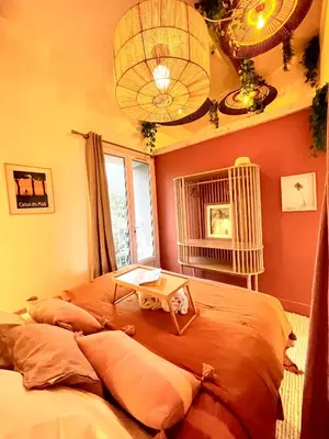 a bedroom with two beds and a table on it at Maison Florence Ivakno in Coudoux