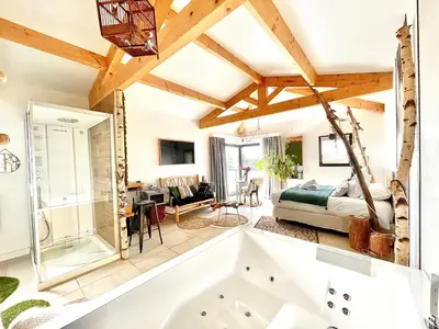 a bedroom with a tub and a bed in a room at Maison Florence Ivakno in Coudoux