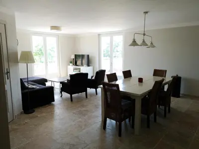 a living room with a dining room table and chairs at Entre Vignes et Collines in Méthamis