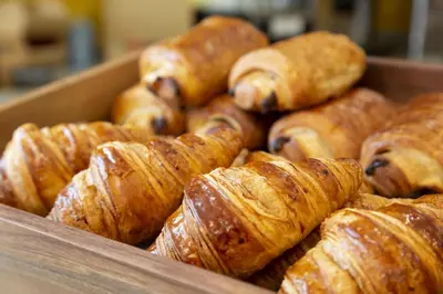 a box of croissants and other pastries at Appart'hôtel Odalys City - Aix en Provence Centre Rotonde in Aix-en-Provence