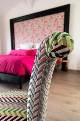 a bedroom with a bed with pink sheets and a blanket at Chut ! c'est ici in Venelles