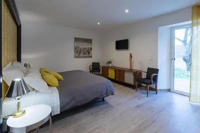 a bedroom with a bed and a desk and a tv at Chut ! c'est ici in Venelles