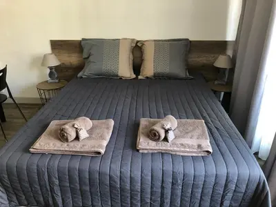 a bedroom with a bed with towels and pillows at Aix Homes in Aix-en-Provence