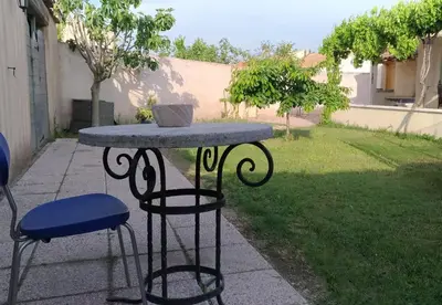 a table with two chairs and a bowl on top of it at L'ilot de Carpentras in Carpentras