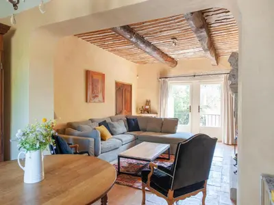a living room with a couch and a table at Villa in Saignon with Pool and Scenic Views in Ménerbes