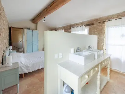 a bathroom with a sink and a bed in a room at Villa in Saignon with Pool and Scenic Views in Ménerbes