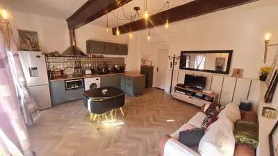 a living room with a couch and a table at Sunny Apartment with Nice View in History City Center in Aix-en-Provence