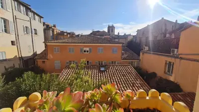 a view of a city with buildings and roofs at Sunny Apartment with Nice View in History City Center in Aix-en-Provence