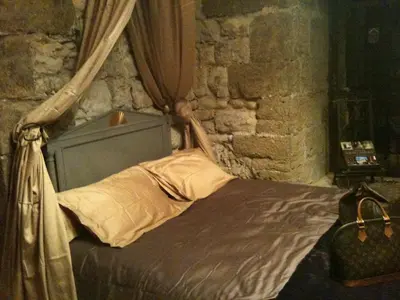 a bedroom with a bed in a stone wall at Château de Vedène in Vedène