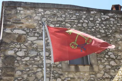 a red flag on a building with a window at Château de Vedène in Vedène