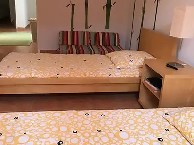 a room with two beds and a nightstand and a bed sidx sidx at Villa in Saumane near Golf Course and Pool in Saumane-de-Vaucluse