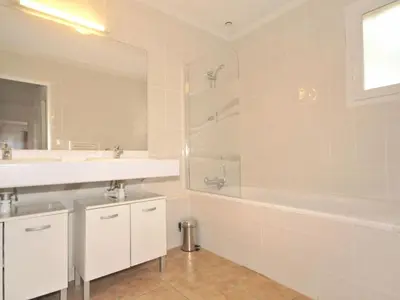 a bathroom with two sinks and a tub and a shower at Villa in Saumane near Golf Course and Pool in Saumane-de-Vaucluse