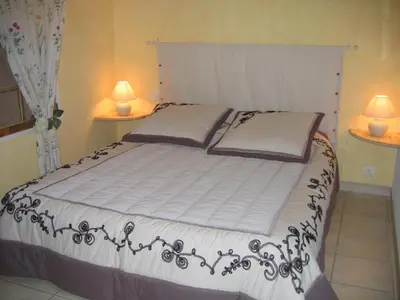 a bedroom with a large bed with two lamps at Les Restanques in Goult