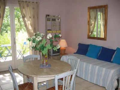a living room with a table and a couch at Les Restanques in Goult