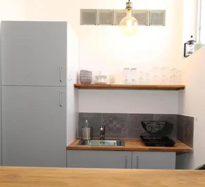 a kitchen with a sink and a refrigerator at 