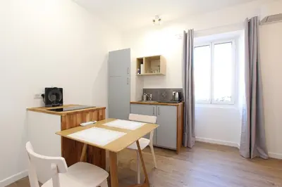 a small kitchen with a table and a table and chairs at 