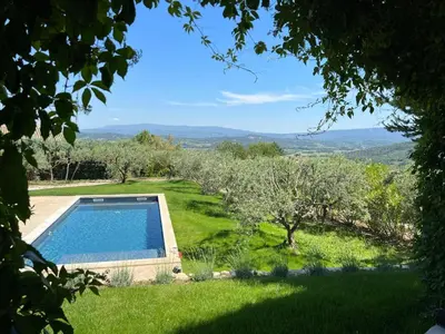 a garden with a swimming pool and an apple orchard at Mas De Gordes in Gordes