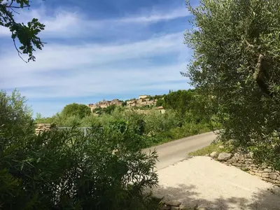 a road with trees and houses on a hill at Mas De Gordes in Gordes