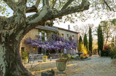 a patio with two chairs and a fire place at Les Colombes in Lagnes