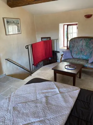 a living room with a couch and a table at Rose in Bonnieux