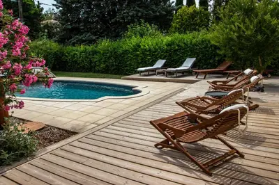 a group of chairs sitting next to a swimming pool at Villa in Provence with private pool in LʼIsle-sur-la-Sorgue