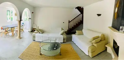 a living room with a couch and a table at Villa in Provence with private pool in LʼIsle-sur-la-Sorgue