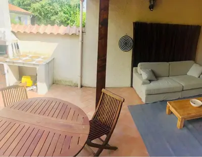 a living room with a couch and a table at Villa in Provence with private pool in LʼIsle-sur-la-Sorgue