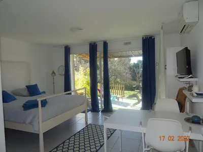 a bedroom with a bed and a desk and a window at Les Ecrins d'Aix-en-Provence in Aix-en-Provence