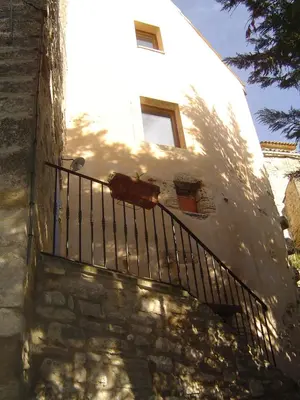a building with a staircase leading up to a window at L'Oustaou de Rose in Bonnieux